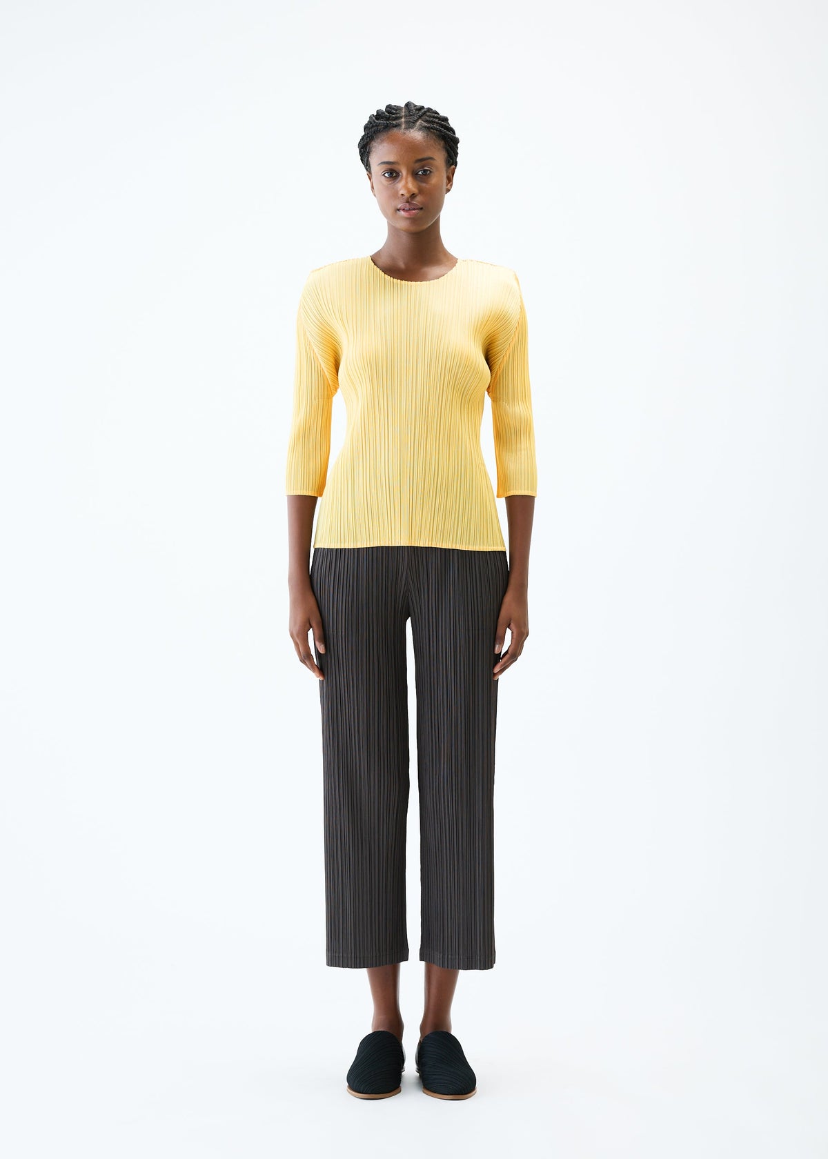 A model wears the PLEATS PLEASE ISSEY MIYAKE THICKER BOTTOMS 2 trousers.