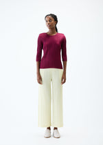 A model wears the PLEATS PLEASE ISSEY MIYAKE THICKER BOTTOMS 2 trousers.