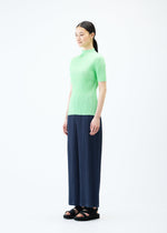 A model wears the PLEATS PLEASE ISSEY MIYAKE LOOP BOTTOMS trousers.