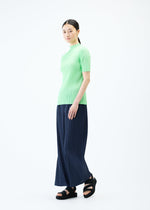 A model wears the PLEATS PLEASE ISSEY MIYAKE LOOP BOTTOMS trousers.