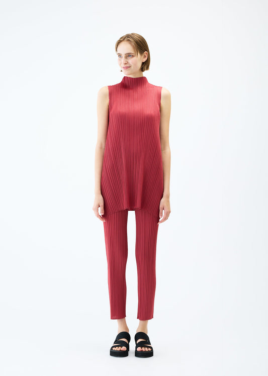 A model wears the PLEATS PLEASE ISSEY MIYAKE LAMP SHADE trousers.