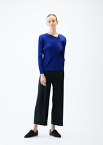 A model wears the PLEATS PLEASE ISSEY MIYAKE LIGHT WAVE trousers.