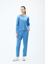 A model wears the PLEATS PLEASE ISSEY MIYAKE COTTON DENIM trousers.
