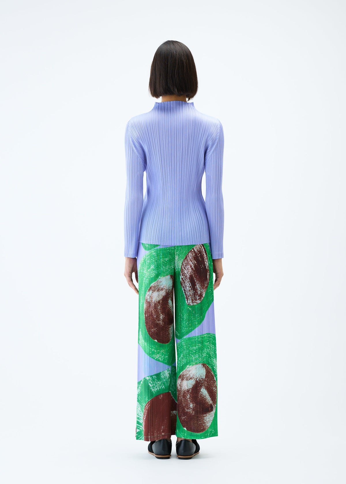 A model wears the PLEATS PLEASE ISSEY MIYAKE BACKLIGHT trousers.