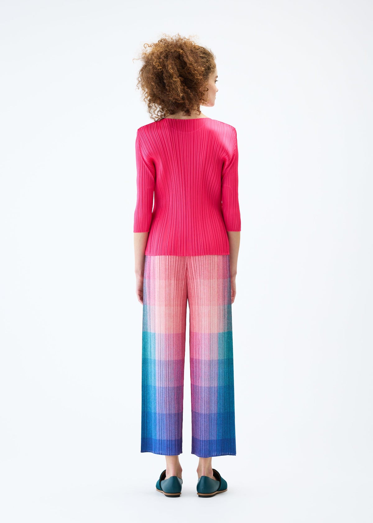 A model wears the PLEATS PLEASE ISSEY MIYAKE PHOTON trousers.