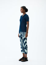 A model wears the PLEATS PLEASE ISSEY MIYAKE REFRACTION trousers.