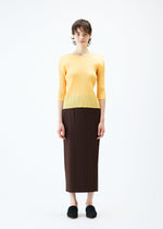 A model wears the PLEATS PLEASE ISSEY MIYAKE MONTHLY COLORS MARCH skirt.