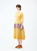 A model wears the PLEATS PLEASE ISSEY MIYAKE PHOTON BOUNCE skirt.