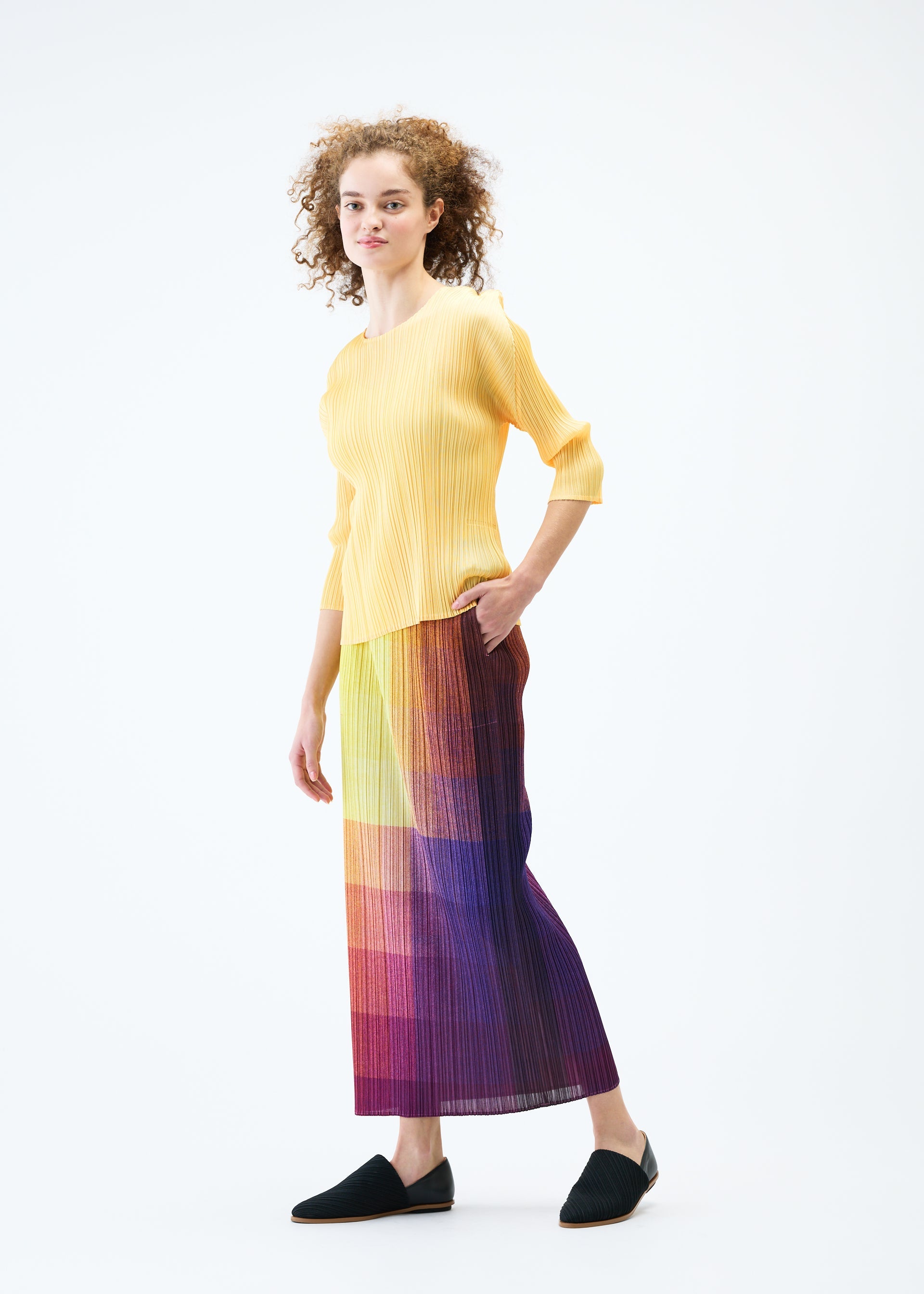 A model wears the PLEATS PLEASE ISSEY MIYAKE PHOTON skirt.