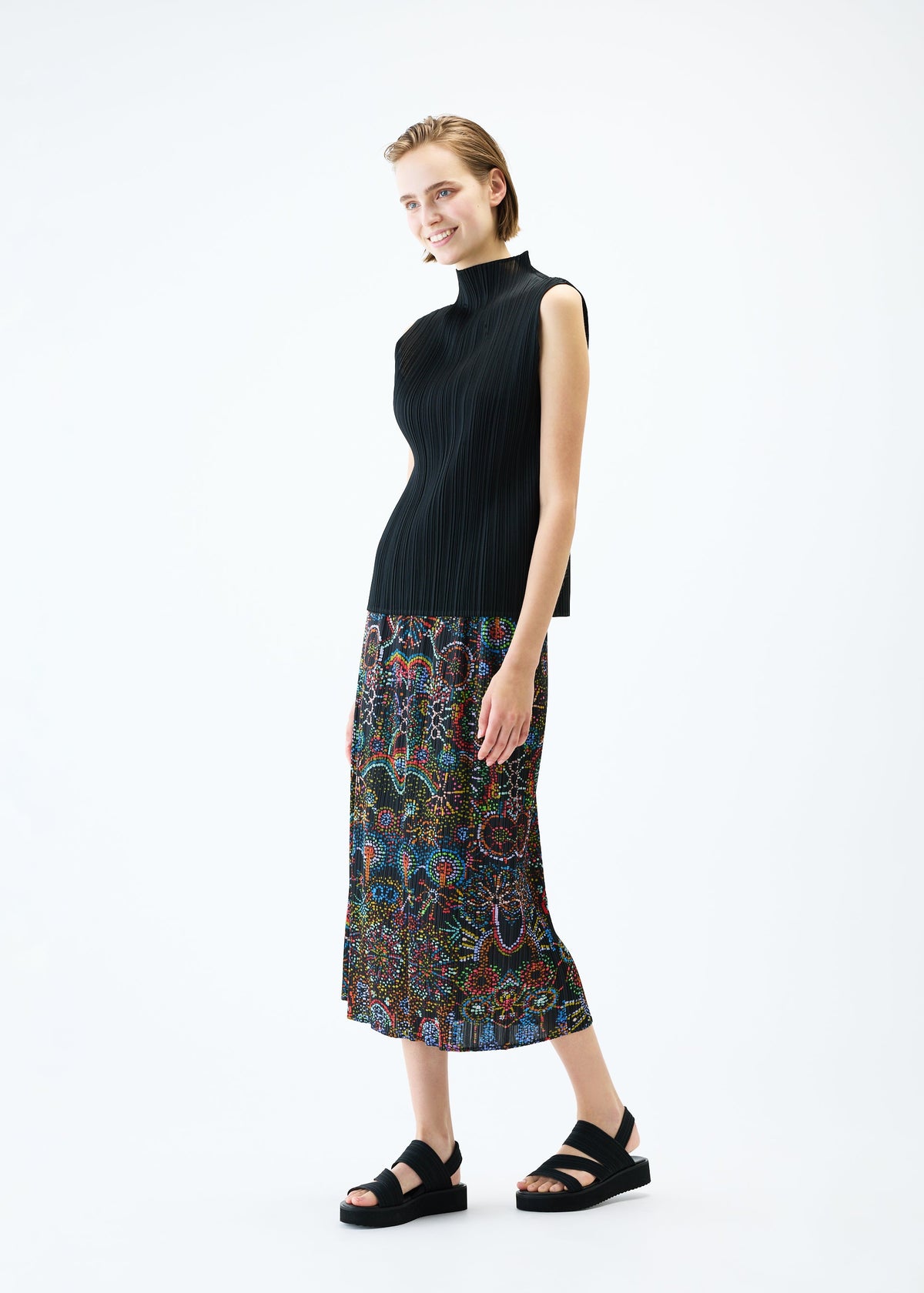 A model wears the PLEATS PLEASE ISSEY MIYAKE LIGHT FESTIVAL skirt.
