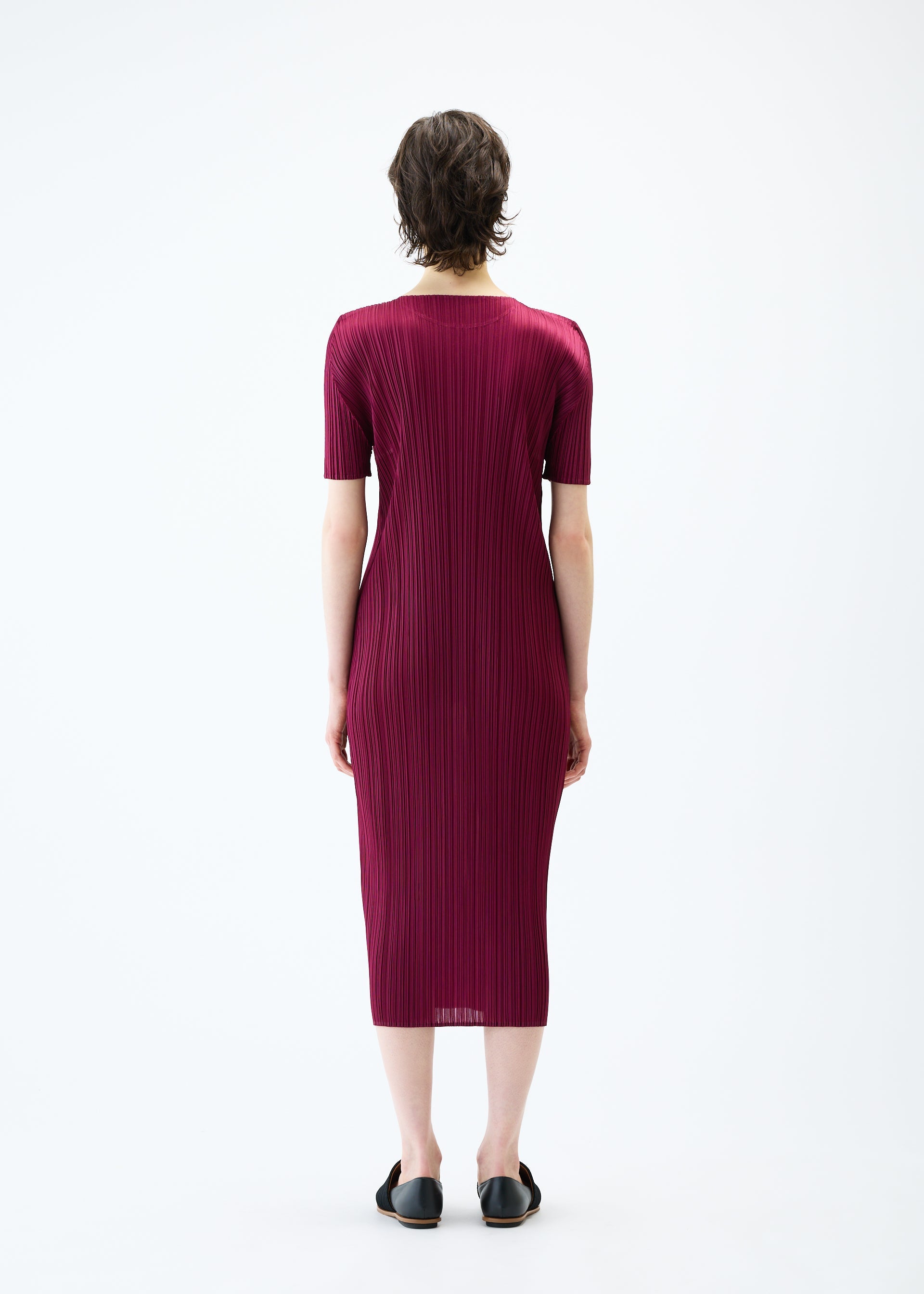 A model wears the PLEATS PLEASE ISSEY MIYAKE MONTHLY COLORS MARCH dress.