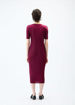 A model wears the PLEATS PLEASE ISSEY MIYAKE MONTHLY COLORS MARCH dress.