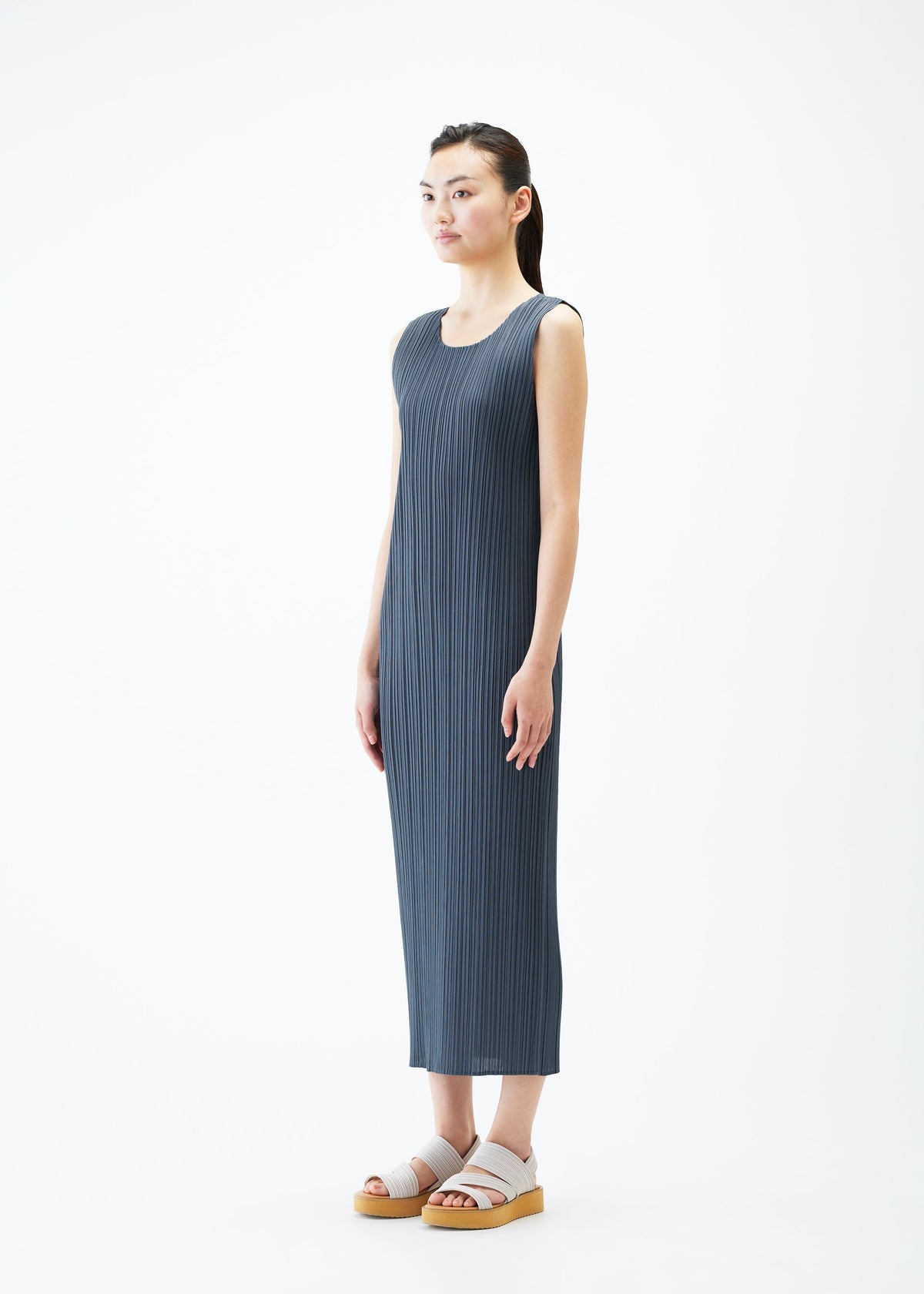 A model wears the PLEATS PLEASE ISSEY MIYAKE MONTHLY COLORS MAY dress.