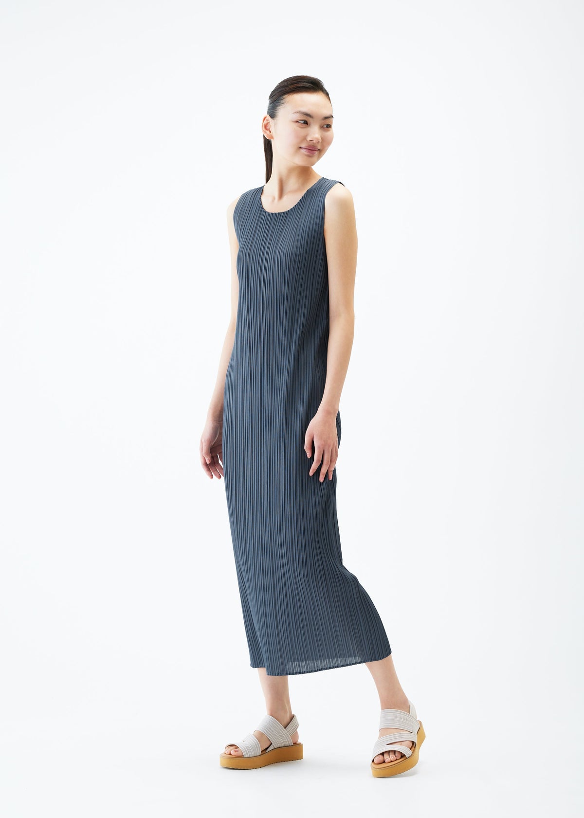 A model wears the PLEATS PLEASE ISSEY MIYAKE MONTHLY COLORS MAY dress.