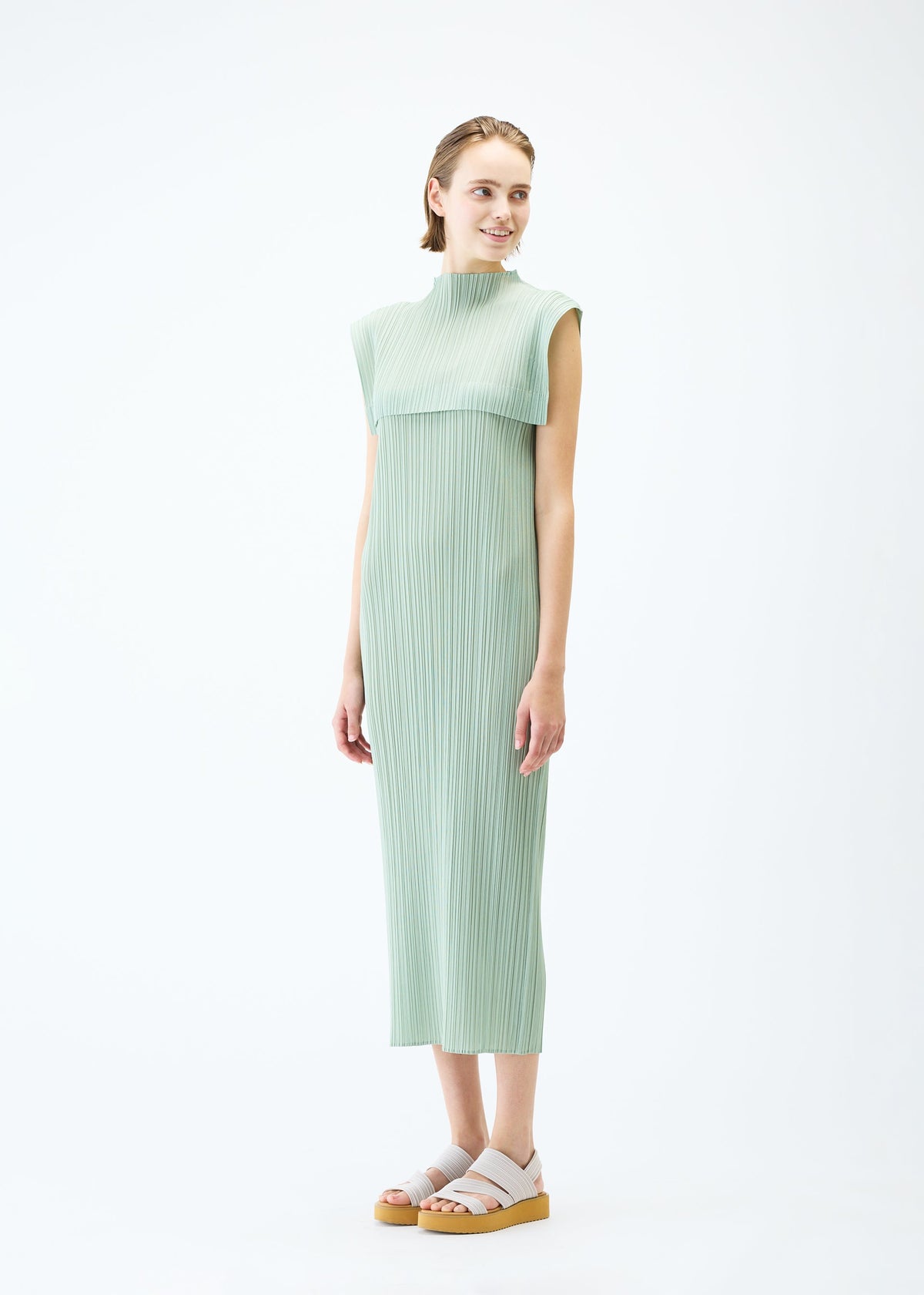 A model wears the PLEATS PLEASE ISSEY MIYAKE MONTHLY COLORS : JUNE dress.