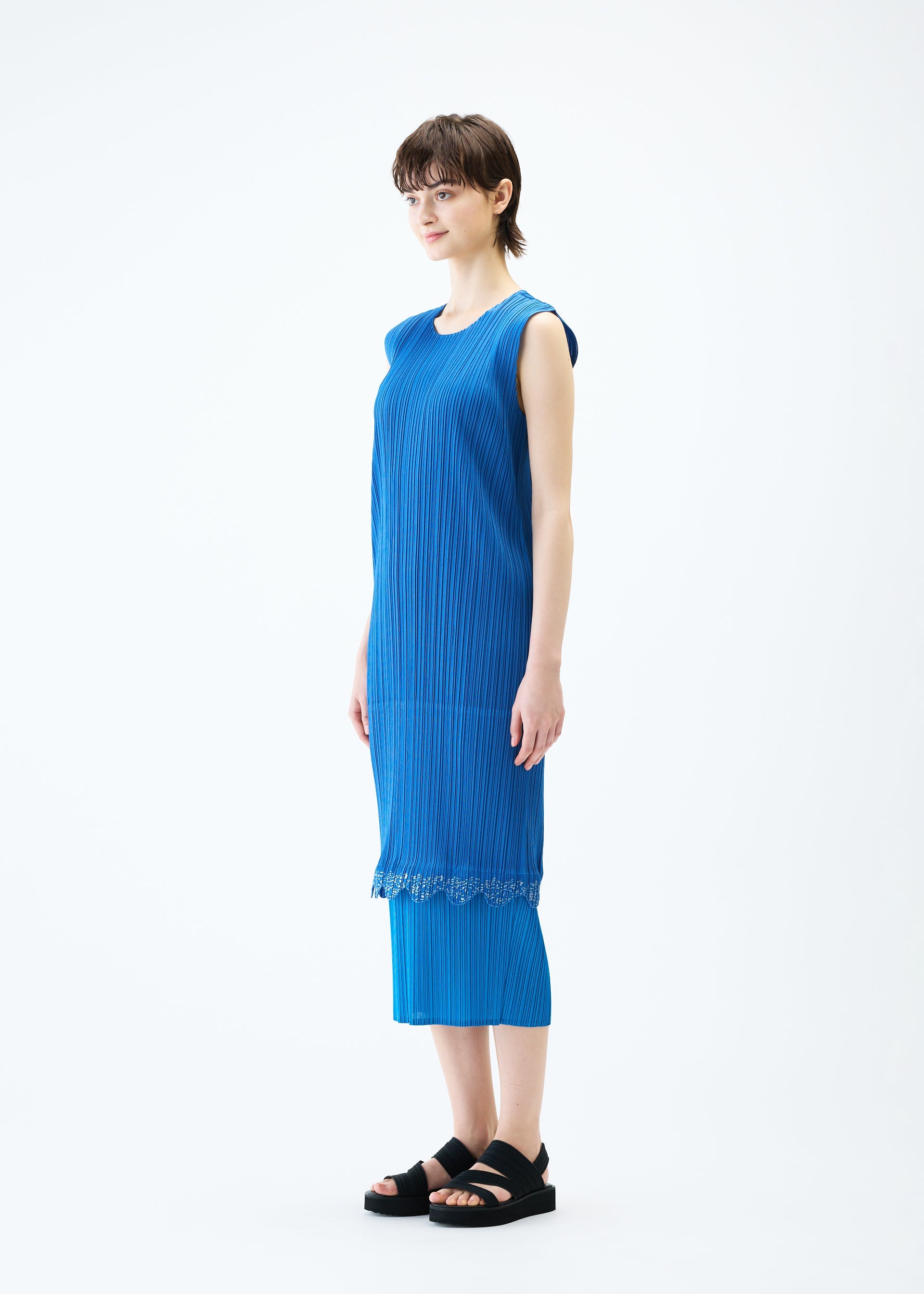 A model wears the PLEATS PLEASE ISSEY MIYAKE TWINKLE dress.