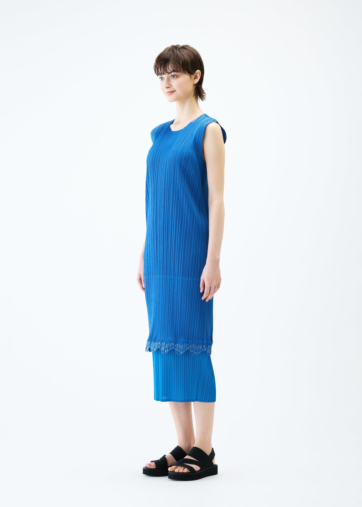 A model wears the PLEATS PLEASE ISSEY MIYAKE TWINKLE dress.