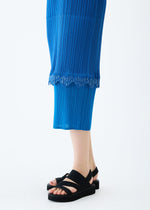 A model wears the PLEATS PLEASE ISSEY MIYAKE TWINKLE dress.