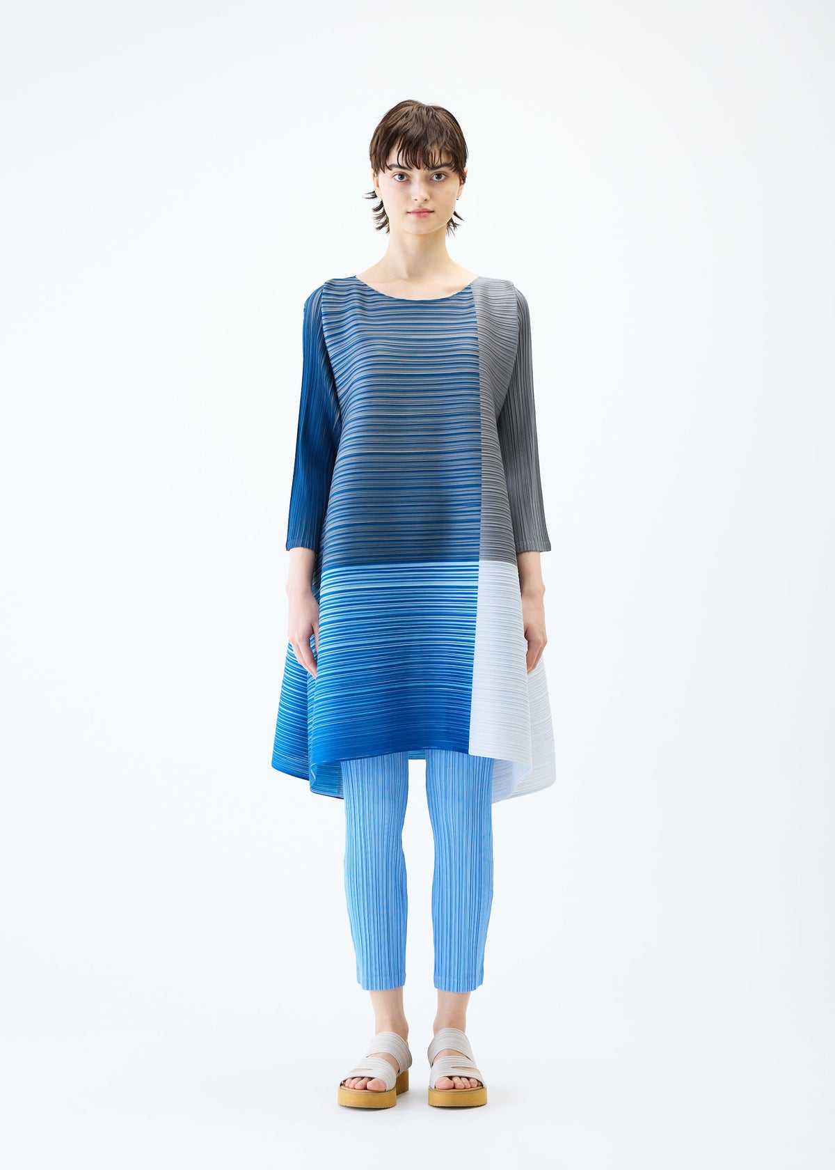 A model wears the PLEATS PLEASE ISSEY MIYAKE PHOTON BOUNCE dress.