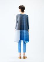 A model wears the PLEATS PLEASE ISSEY MIYAKE PHOTON BOUNCE dress.