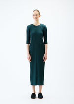 A model wears the PLEATS PLEASE ISSEY MIYAKE MERRY BICOLOR dress.