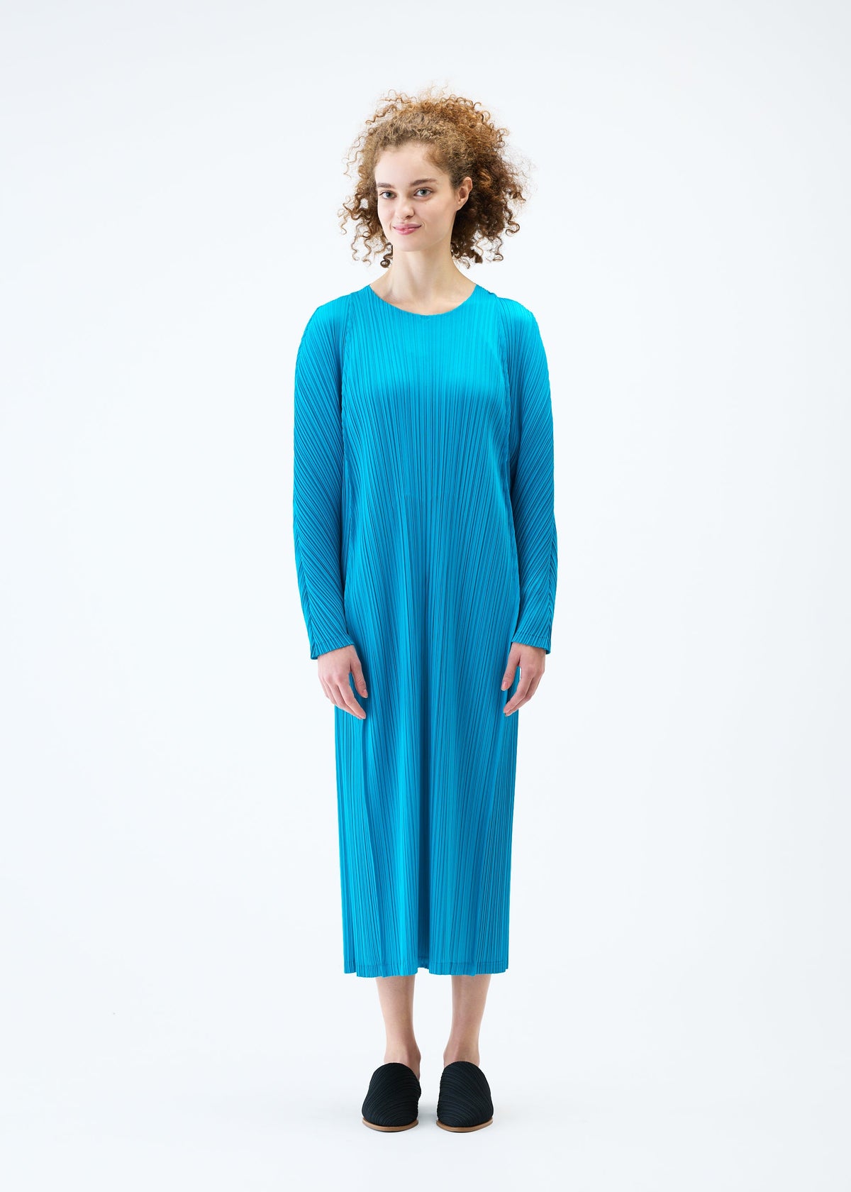 A model wears the PLEATS PLEASE ISSEY MIYAKE LANTERN dress.