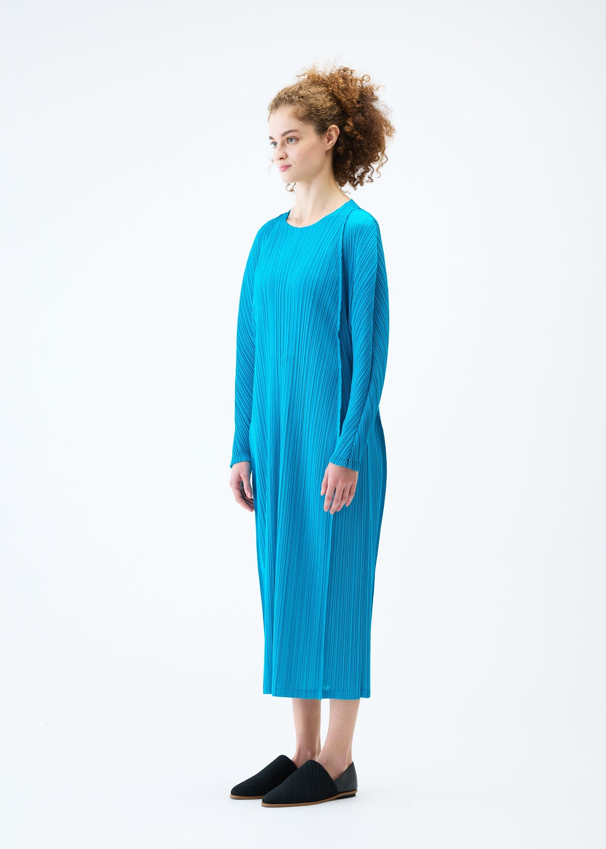 A model wears the PLEATS PLEASE ISSEY MIYAKE LANTERN dress.