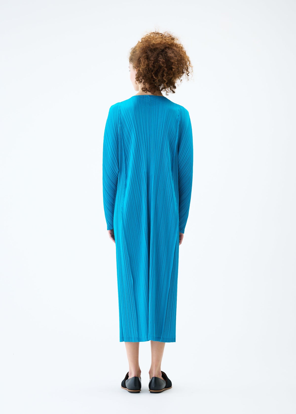 A model wears the PLEATS PLEASE ISSEY MIYAKE LANTERN dress.