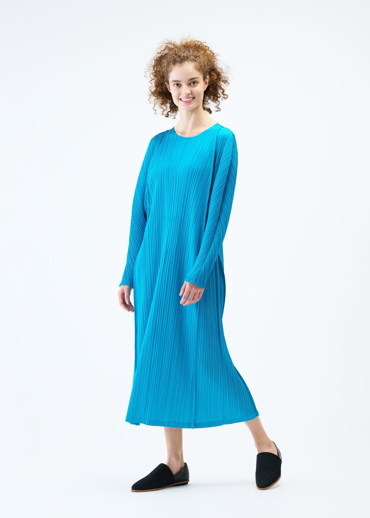 A model wears the PLEATS PLEASE ISSEY MIYAKE LANTERN dress.