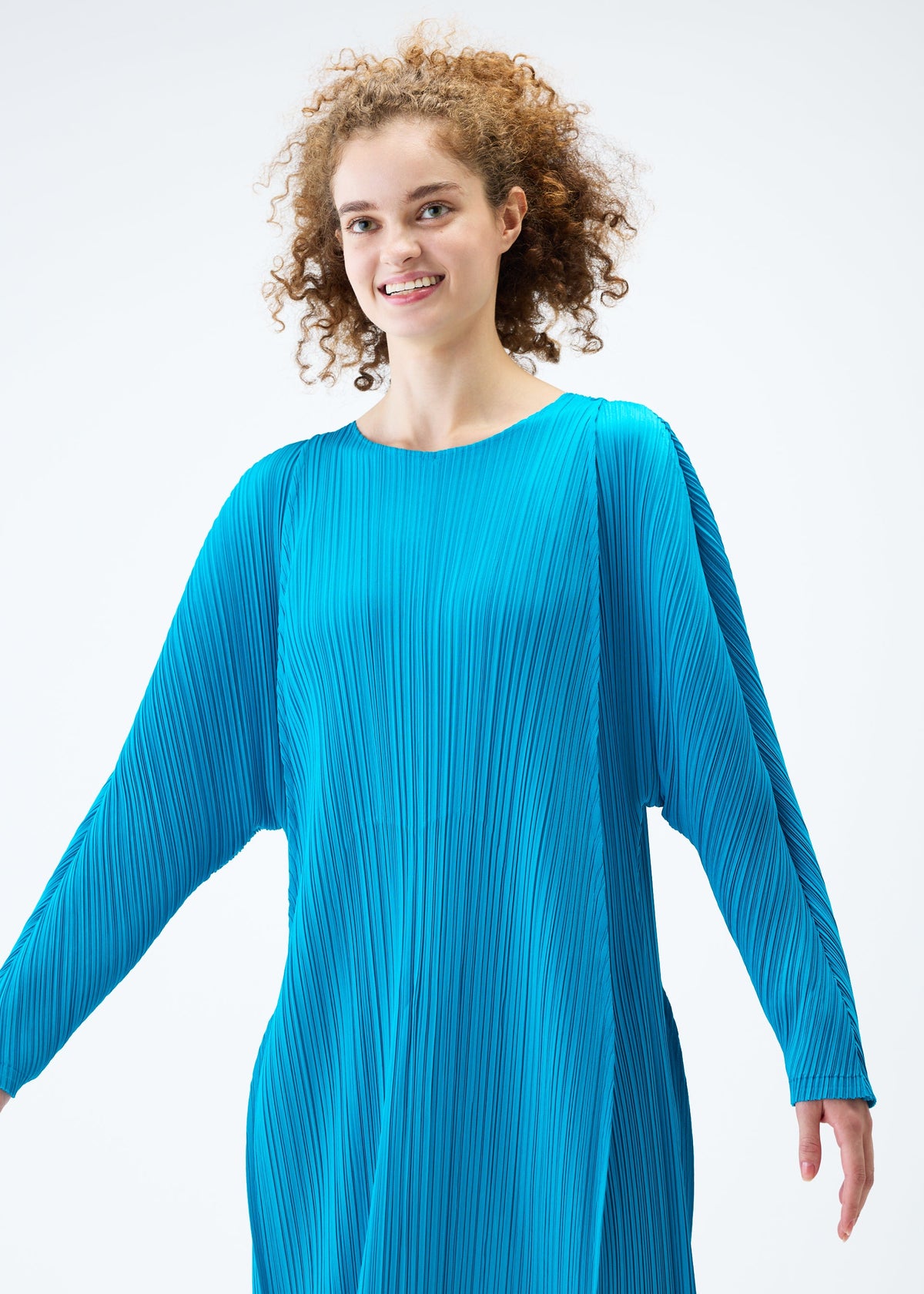 A model wears the PLEATS PLEASE ISSEY MIYAKE LANTERN dress.