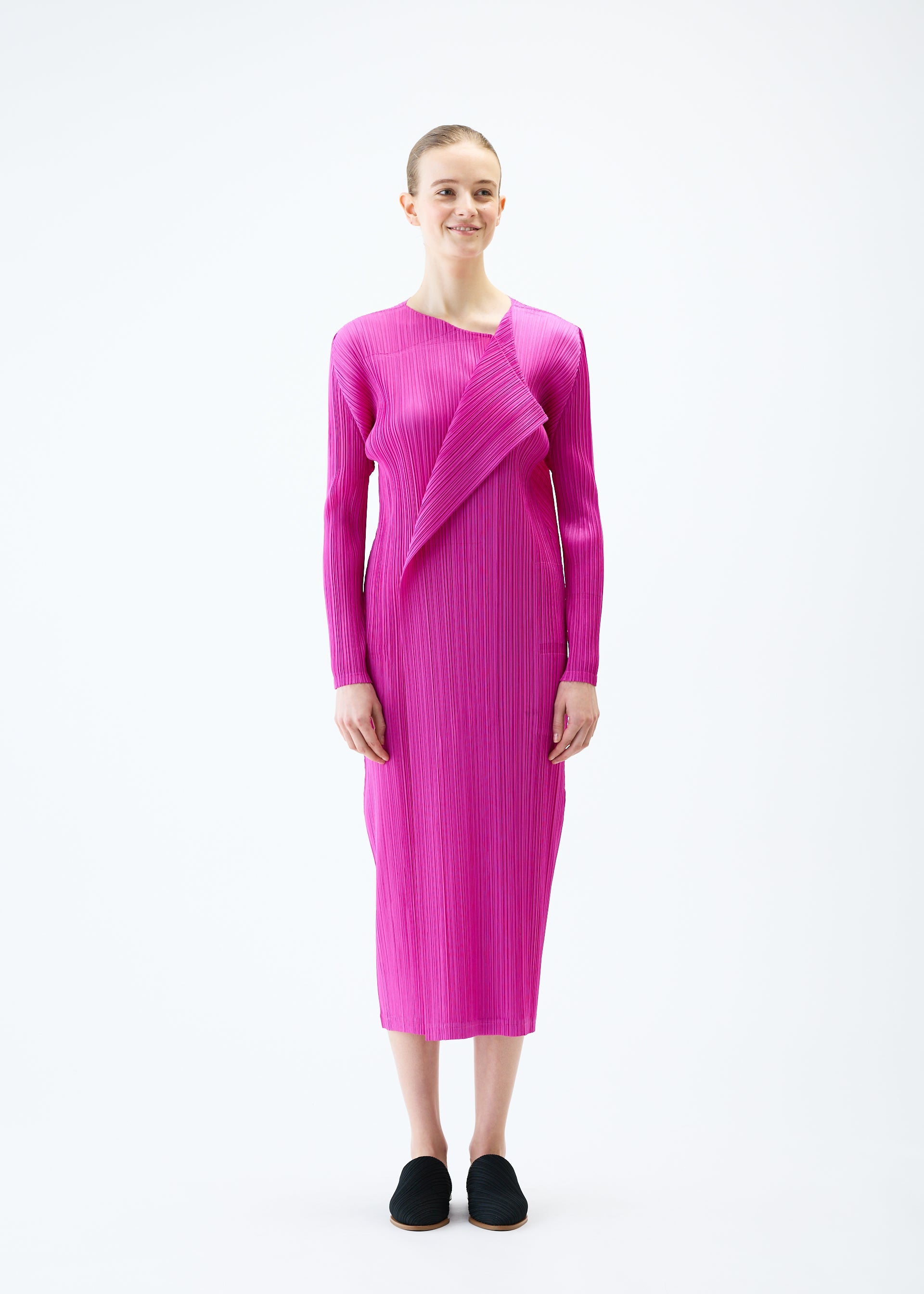 A model wears the PLEATS PLEASE ISSEY MIYAKE LIGHT WAVE dress.