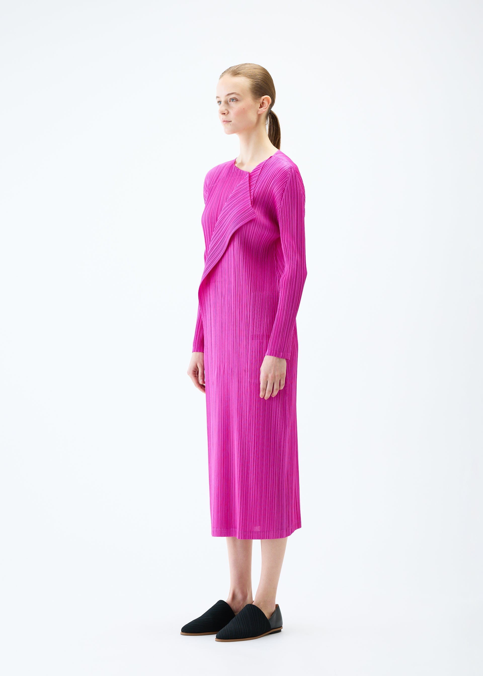 A model wears the PLEATS PLEASE ISSEY MIYAKE LIGHT WAVE dress.