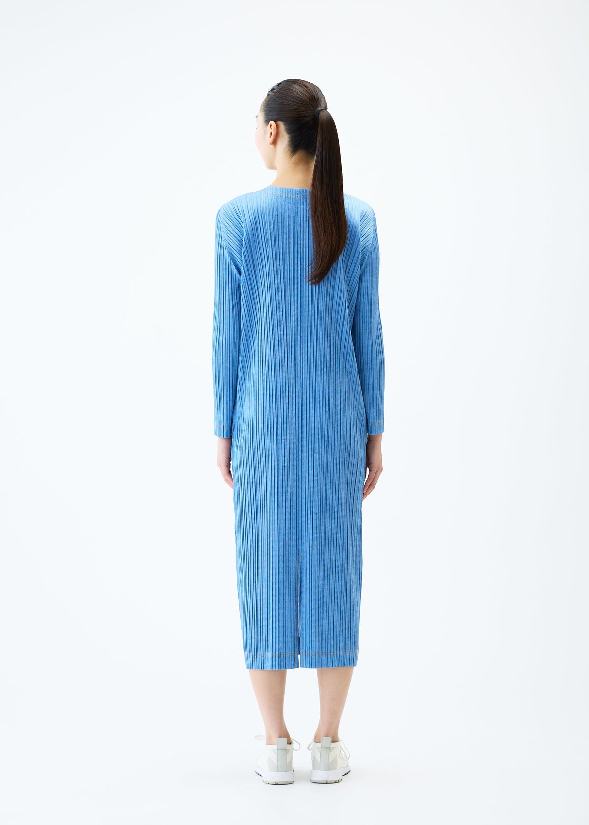 A model wears the PLEATS PLEASE ISSEY MIYAKE COTTON DENIM dress.