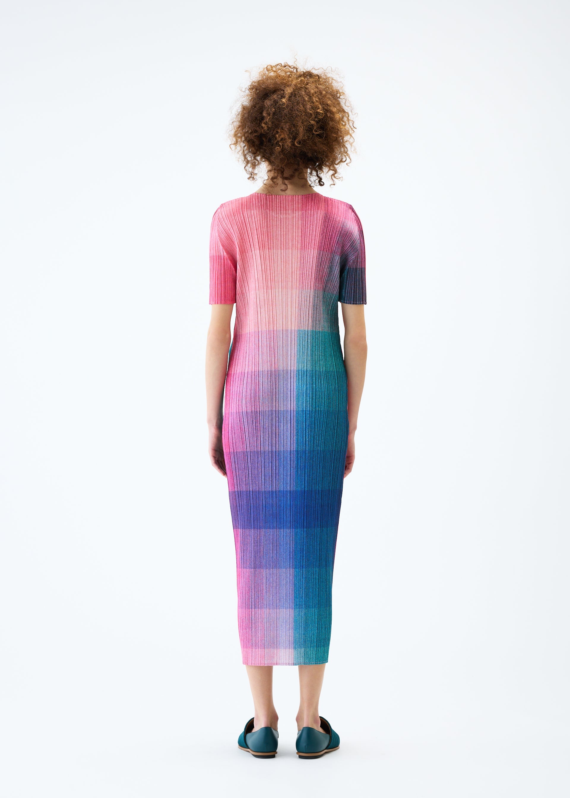 A model wears the PLEATS PLEASE ISSEY MIYAKE PHOTON dress.