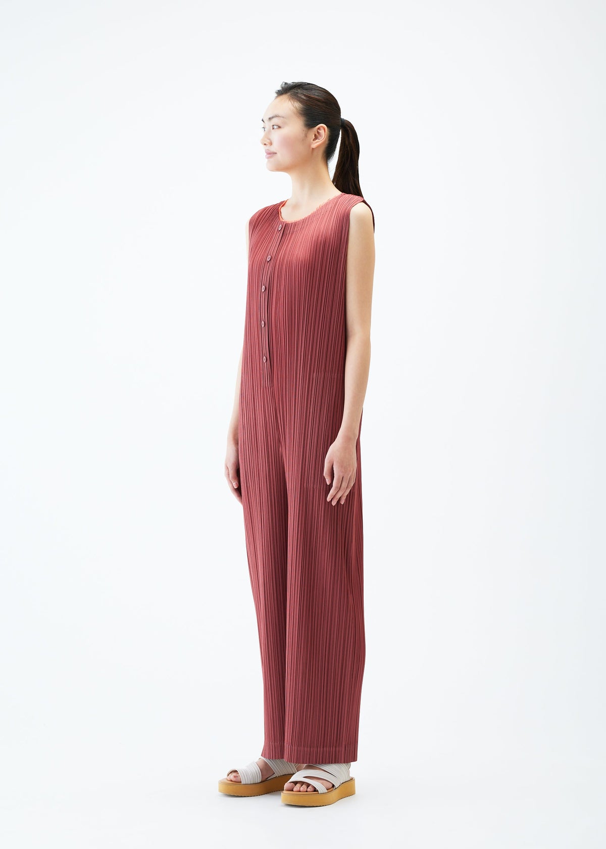 A model wears the PLEATS PLEASE ISSEY MIYAKE MONTHLY COLORS MAY jumpsuit.