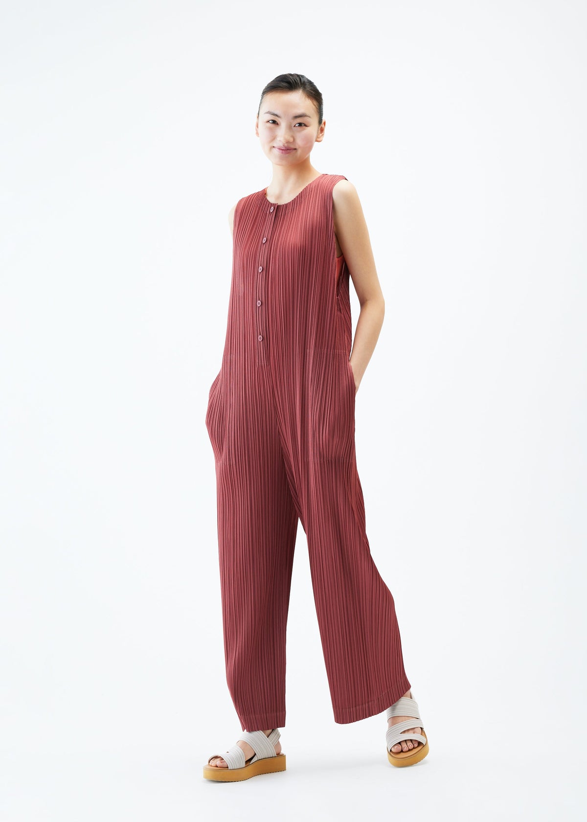 A model wears the PLEATS PLEASE ISSEY MIYAKE MONTHLY COLORS MAY jumpsuit.