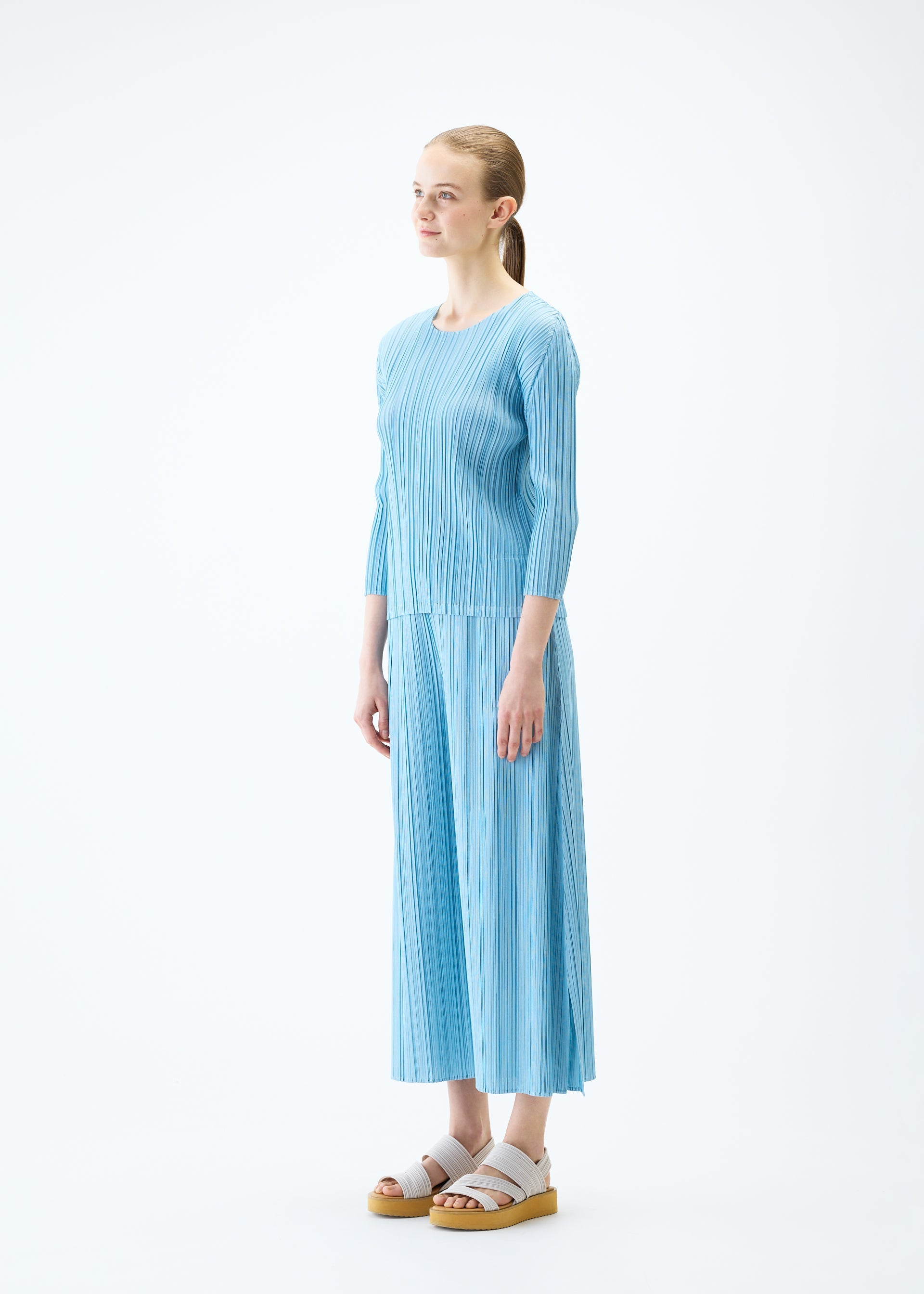A model wears the PLEATS PLEASE ISSEY MIYAKE MELLOW PLEATS top.