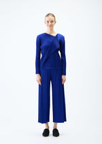 A model wears the PLEATS PLEASE ISSEY MIYAKE LIGHT WAVE top.