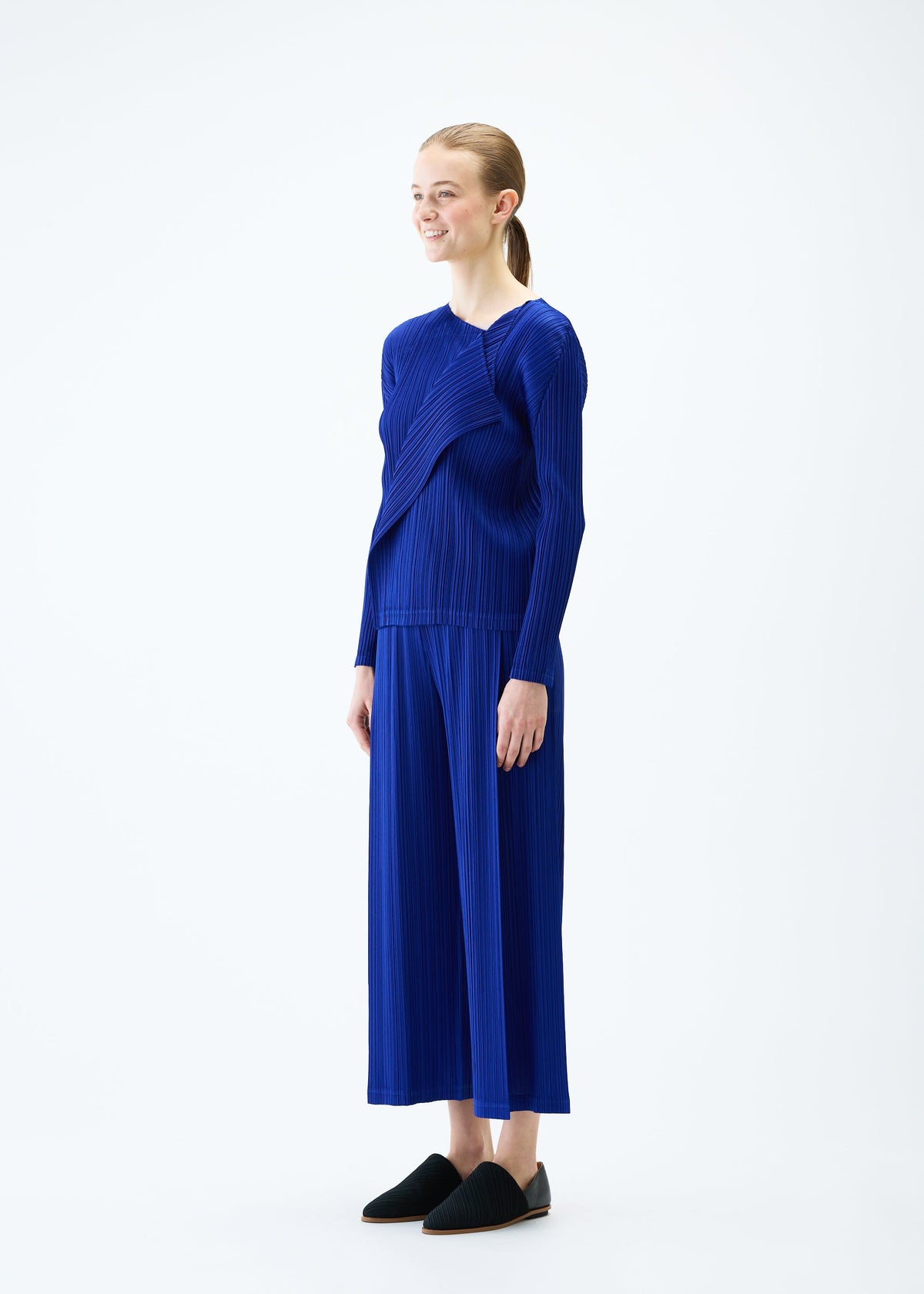 A model wears the PLEATS PLEASE ISSEY MIYAKE LIGHT WAVE top.