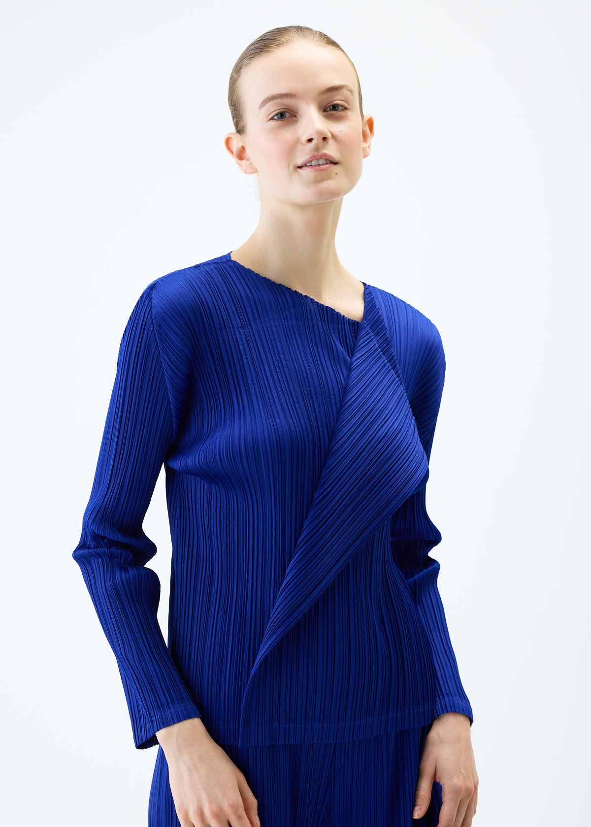 A model wears the PLEATS PLEASE ISSEY MIYAKE LIGHT WAVE top.