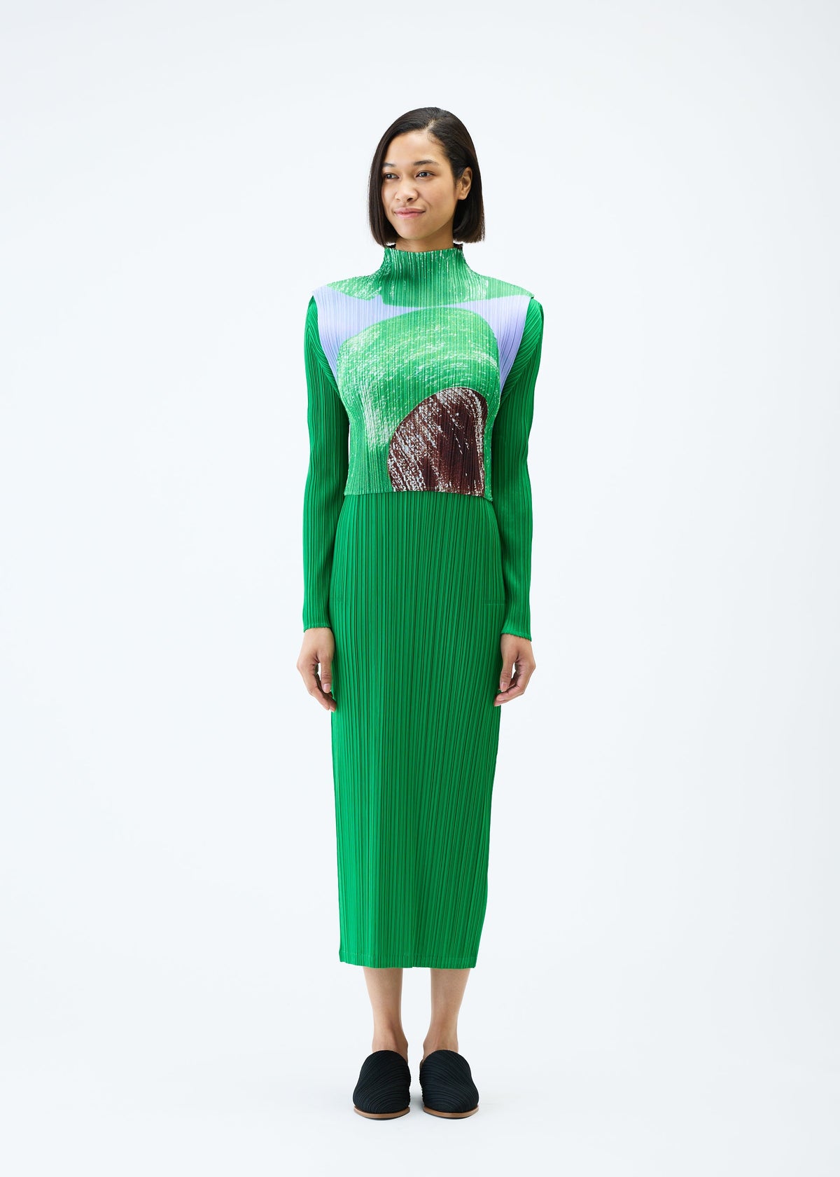 A model wears the PLEATS PLEASE ISSEY MIYAKE BACKLIGHT top.