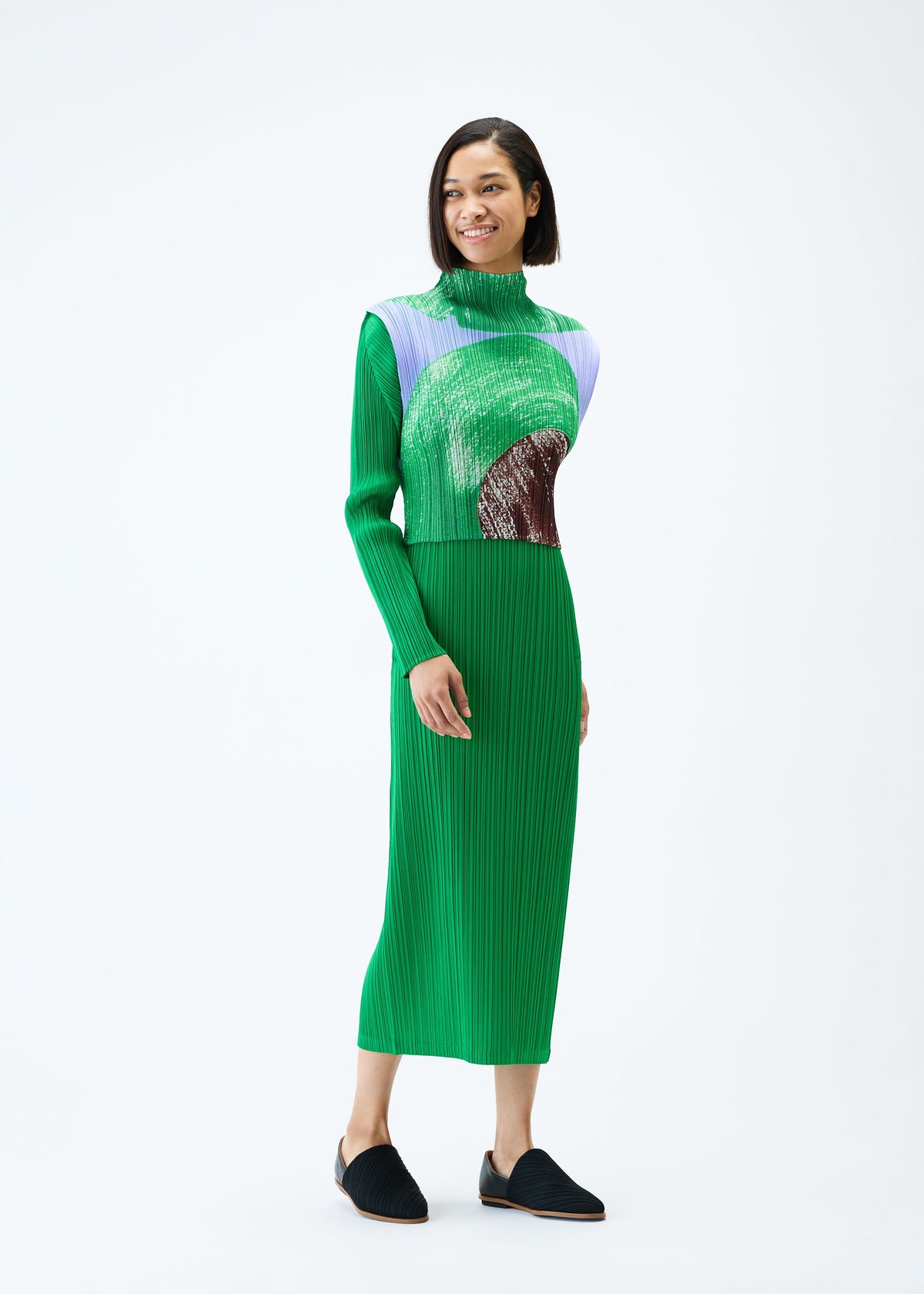 A model wears the PLEATS PLEASE ISSEY MIYAKE BACKLIGHT top.