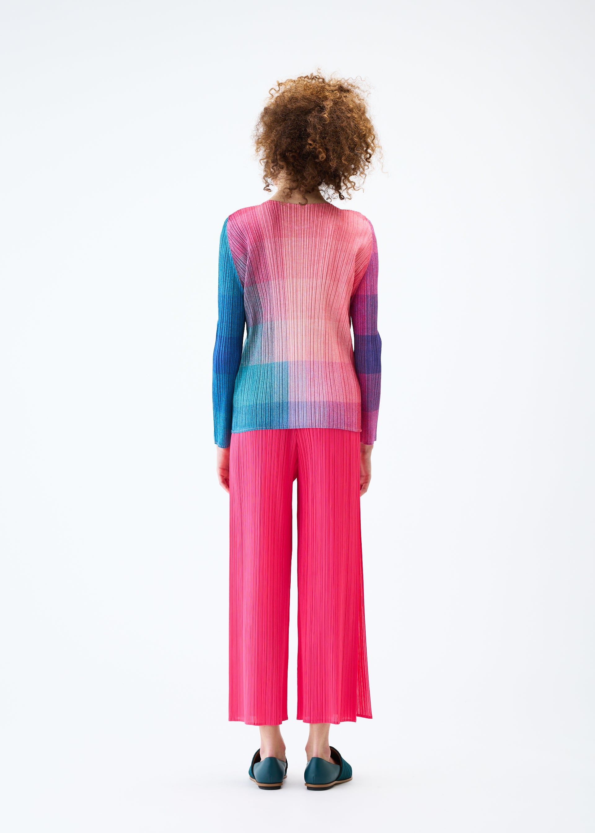 A model wears the PLEATS PLEASE ISSEY MIYAKE PHOTON top.