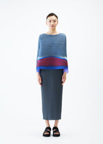 A model wears the PLEATS PLEASE ISSEY MIYAKE GRAINY COLORS top.