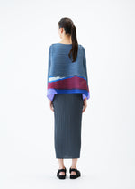 A model wears the PLEATS PLEASE ISSEY MIYAKE GRAINY COLORS top.