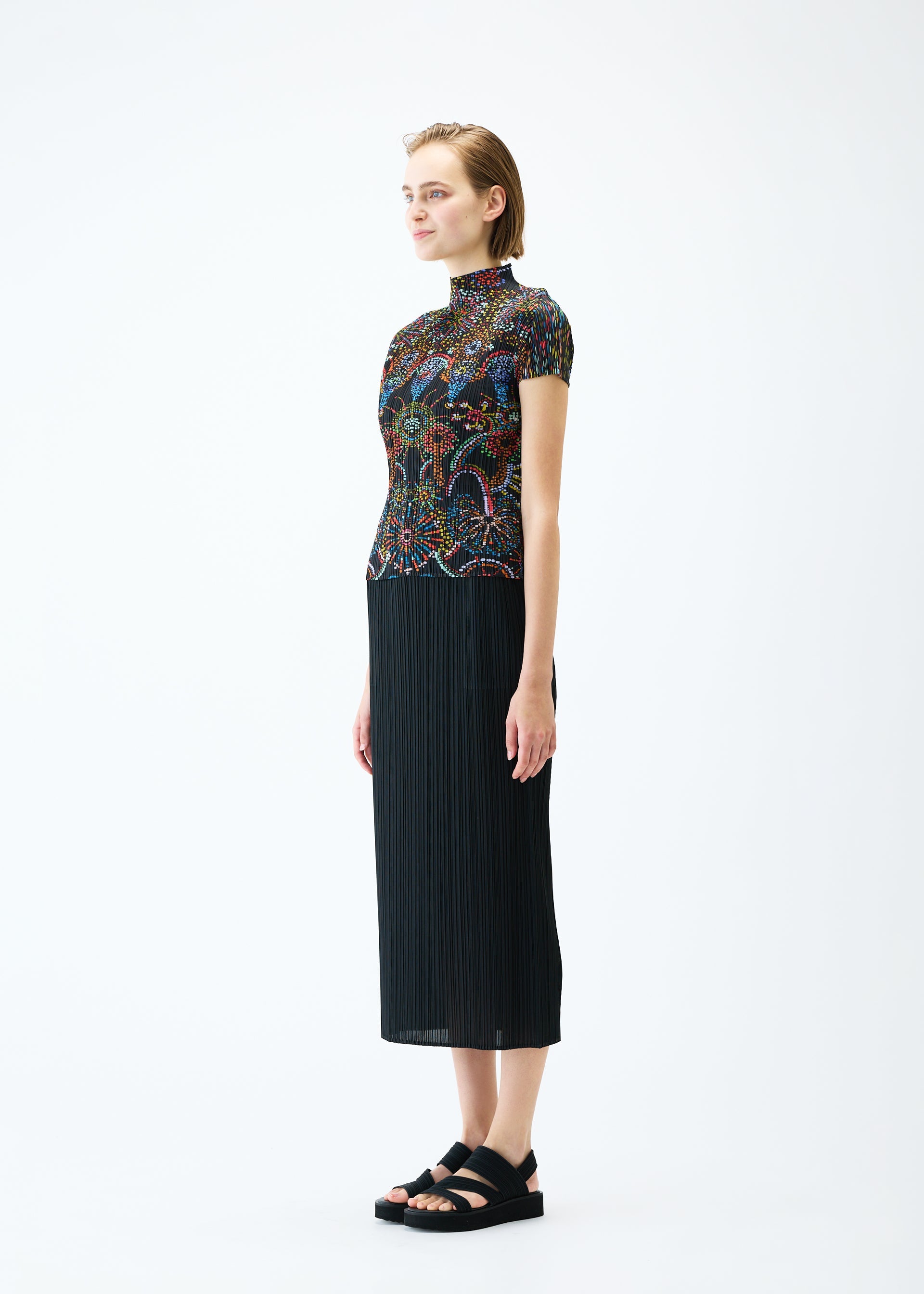 A model wears the PLEATS PLEASE ISSEY MIYAKE LIGHT FESTIVAL top.