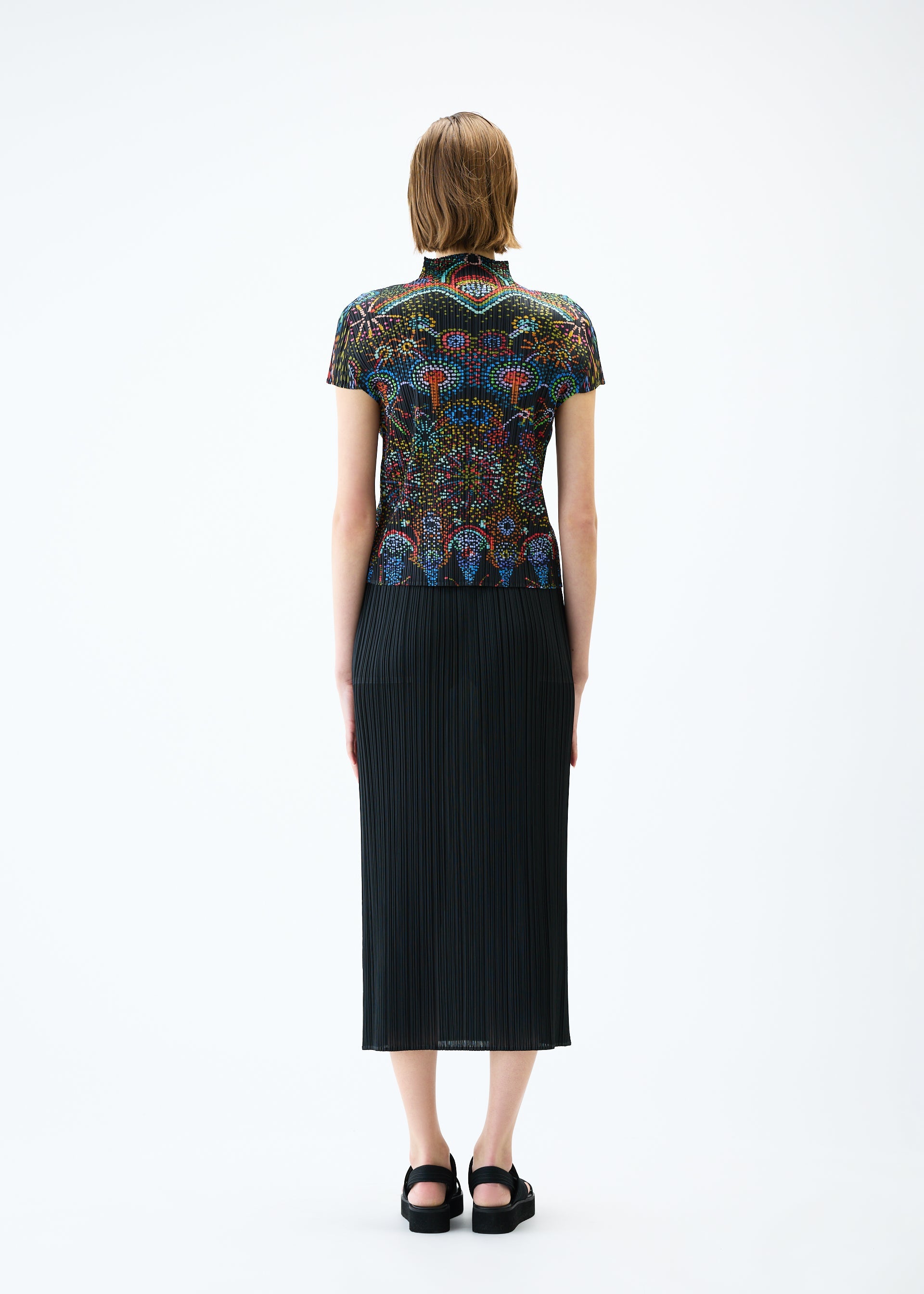 A model wears the PLEATS PLEASE ISSEY MIYAKE LIGHT FESTIVAL top.