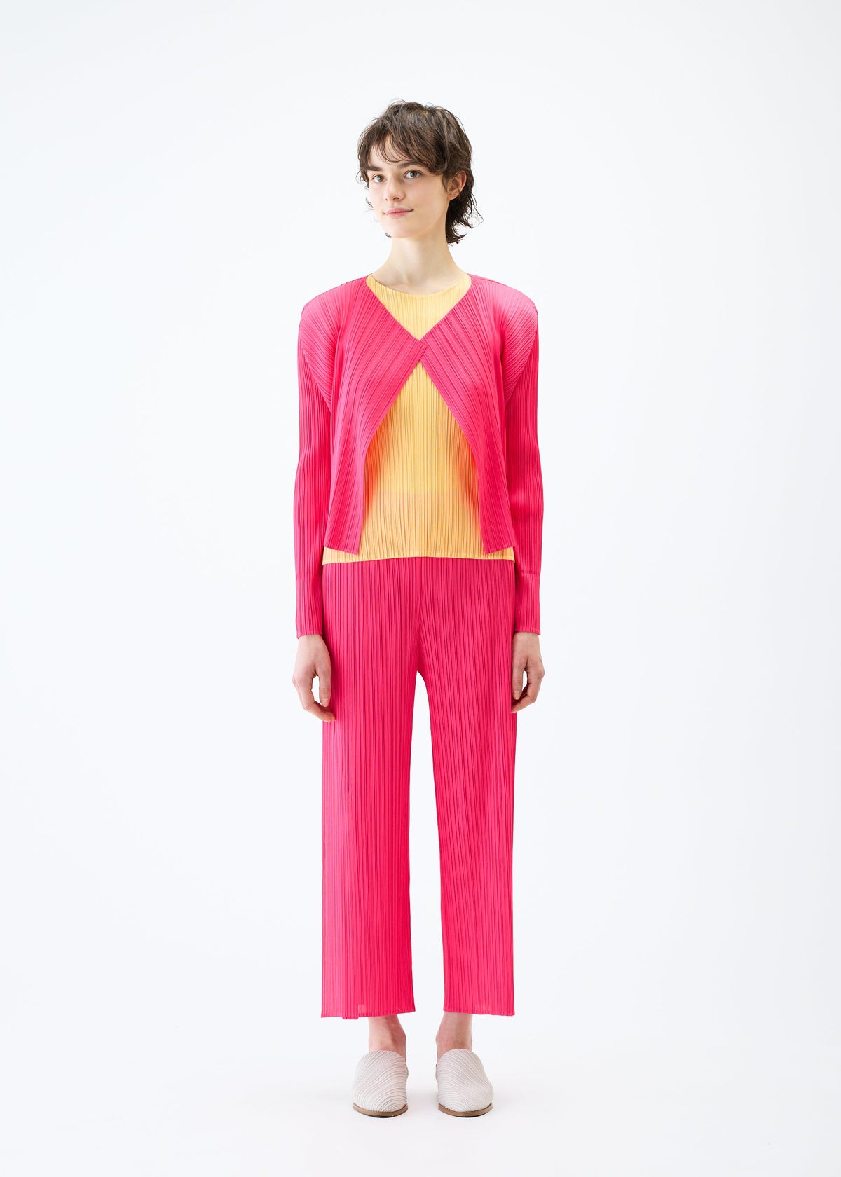 A model wears the PLEATS PLEASE ISSEY MIYAKE MONTHLY COLORS MARCH cardigan.