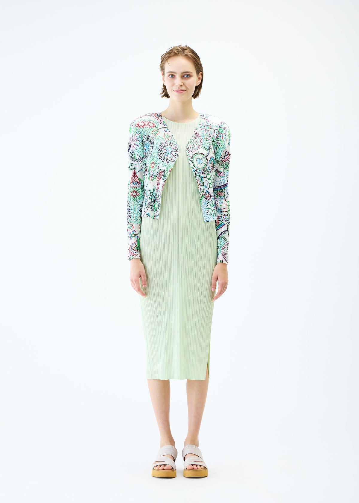 A model wears the PLEATS PLEASE ISSEY MIYAKE LIGHT FESTIVAL cardigan.