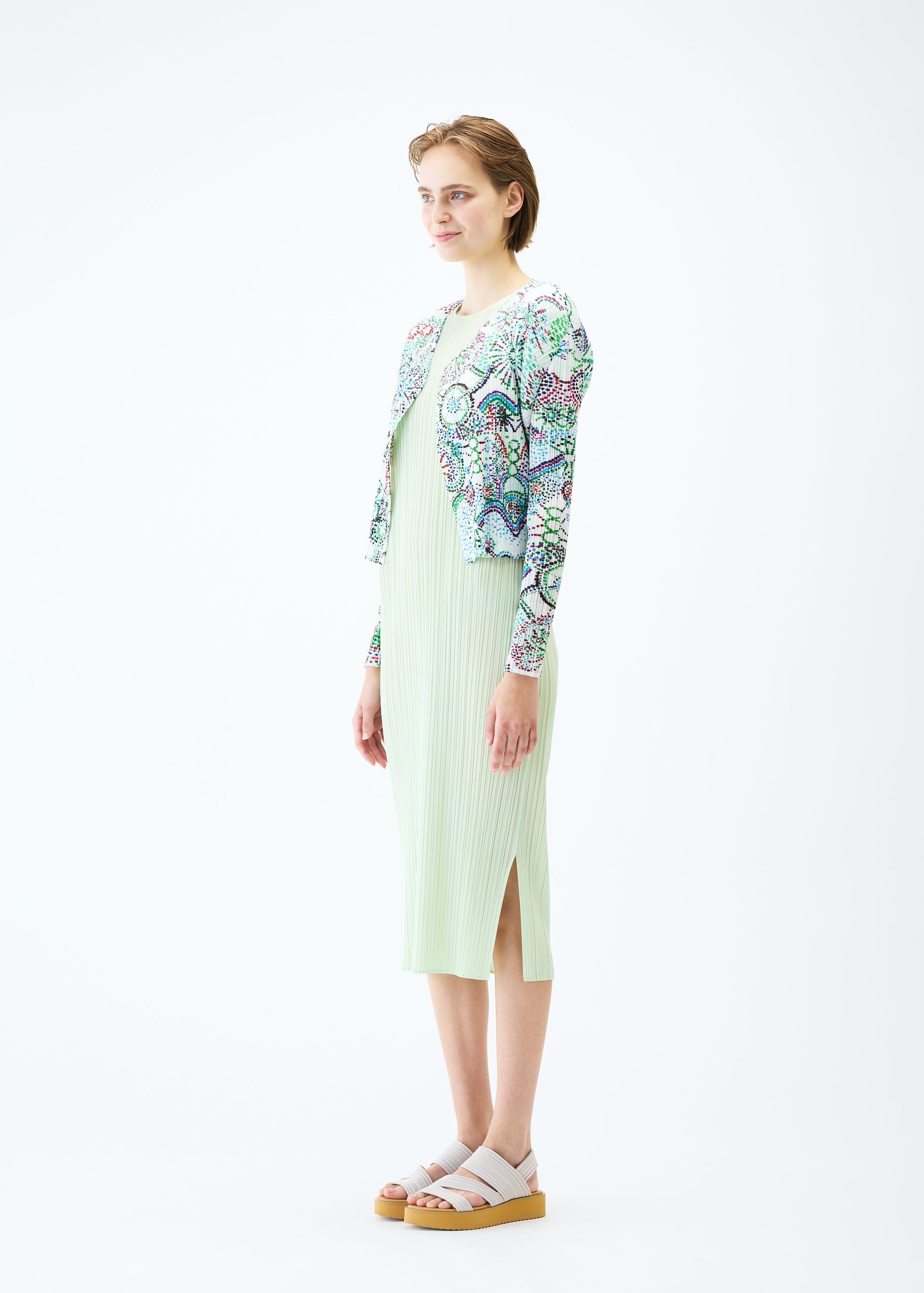 A model wears the PLEATS PLEASE ISSEY MIYAKE LIGHT FESTIVAL cardigan.